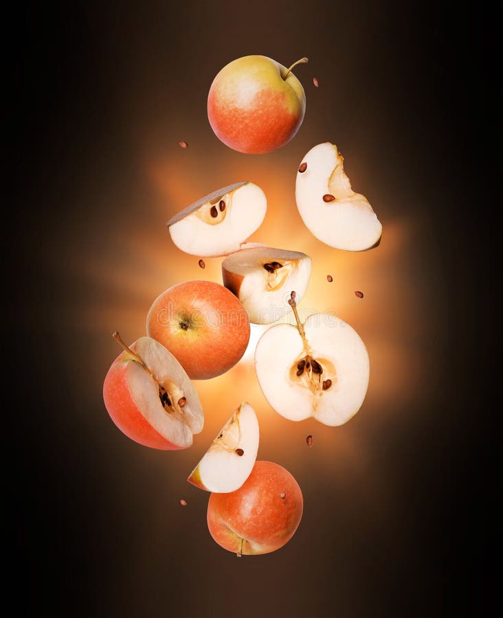 Whole and Sliced Fresh Apples in the Air with Flash of Light in the ...