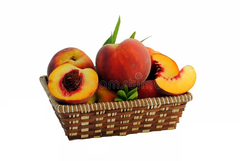 Whole and sliced peaches in a straw basket