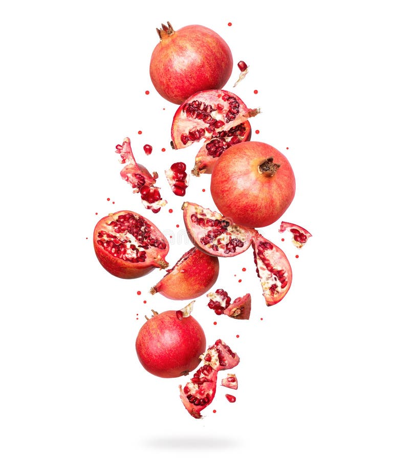 Whole and sliced â€‹â€‹fresh pomegranate in the air, isolated on white background