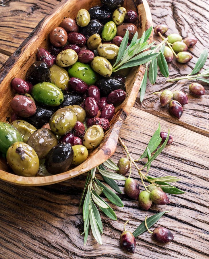 Whole Table Olives in the Wooden Bowl on the Table. Stock Image Image