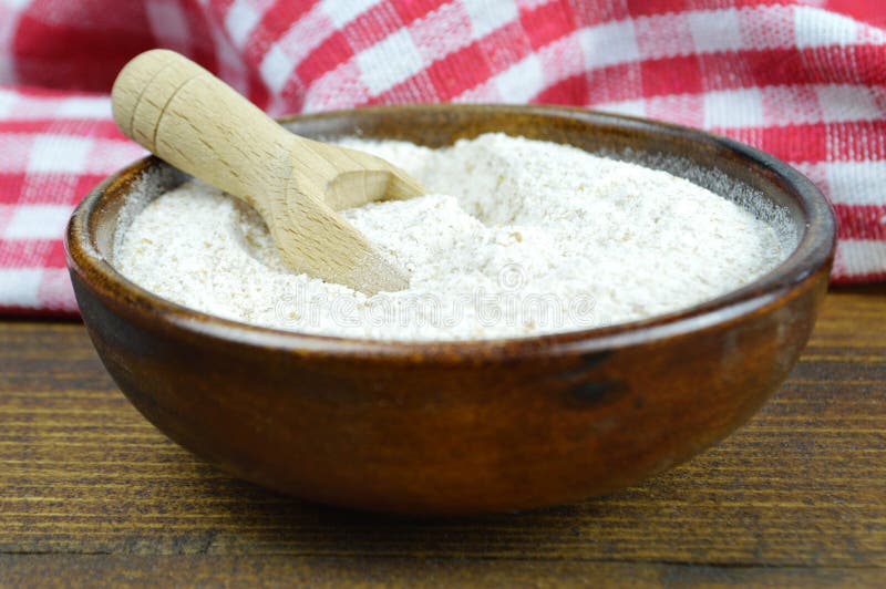 Whole wheat flour in wooden bowl