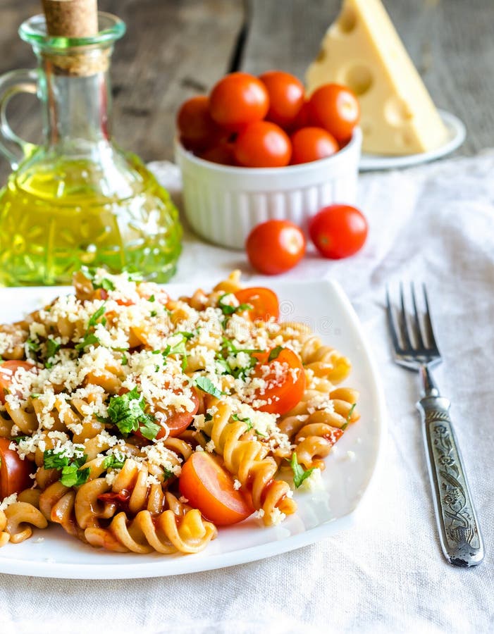 Whole Wheat Fusilli Pasta with Cheese and Cherry Tomatoes Stock Image