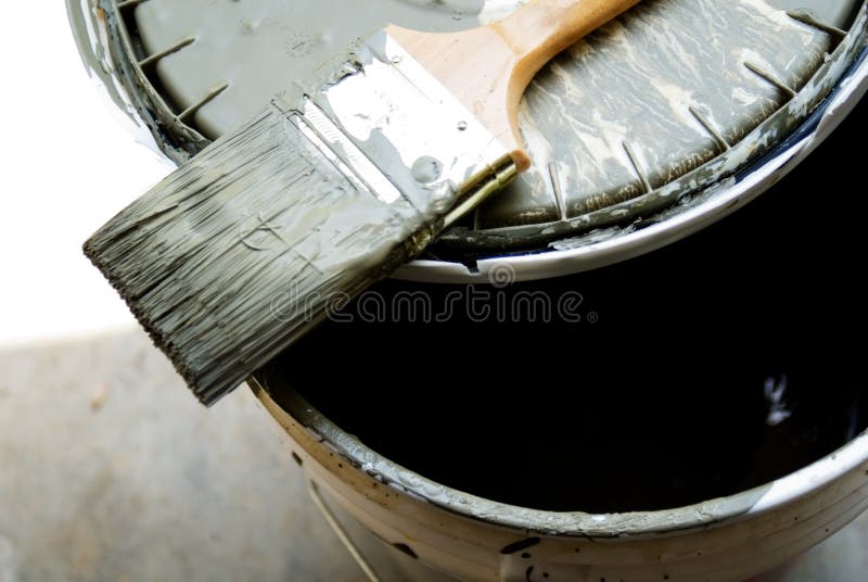 A paint brush on top of a bucket, a very popular shade of green for homes. A paint brush on top of a bucket, a very popular shade of green for homes.