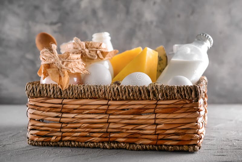 Wicker Basket with Different Milk Products on Grey Table Stock Image