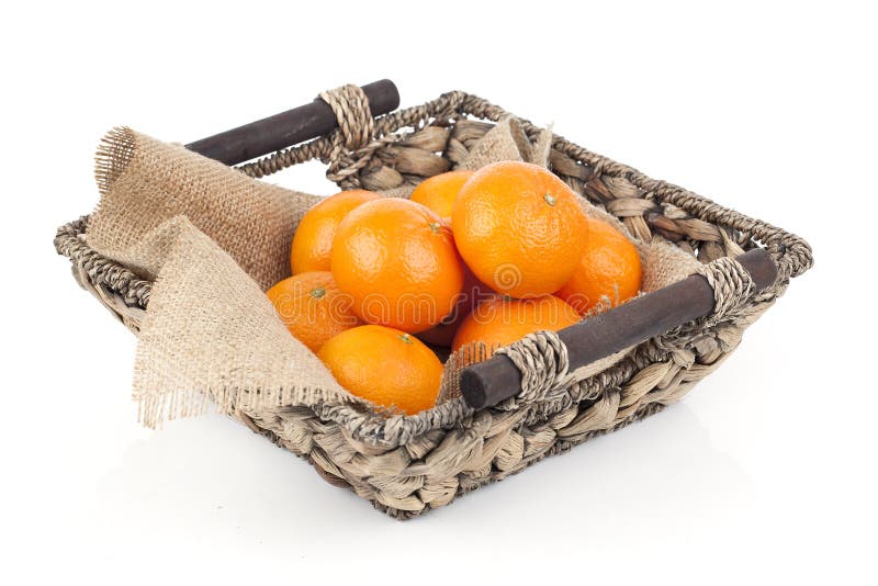 Wicker basket full of fresh orange fruits