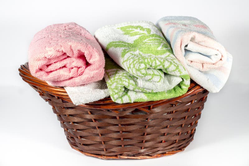 Wicker Basket with Hand Towels of Different Colors and Patterns Stock