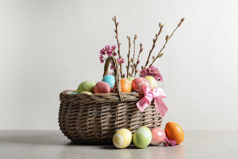 Wicker Basket with Painted Easter Eggs and Flowers Stock Photo - Image ...