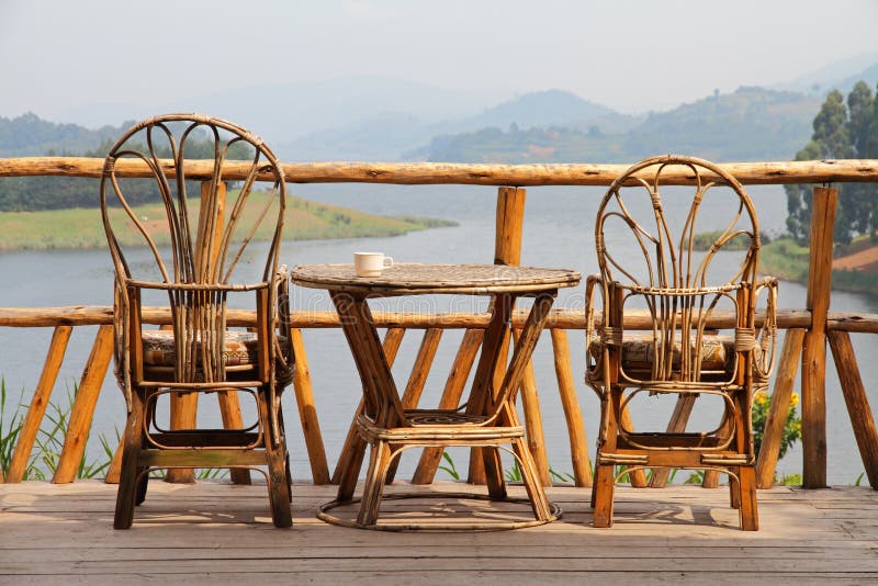 Wicker Deck Chairs with Coffee on a Table and a Lake View