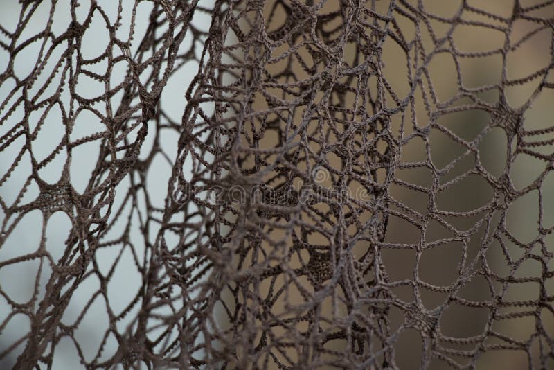 Wicker mesh of threads as a background with a soft blurred focus in the dark as a background ,abstract background