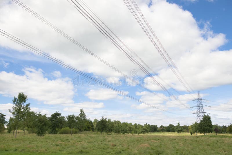 Wide angle lines of over head power cables converging to a pylon stock photography