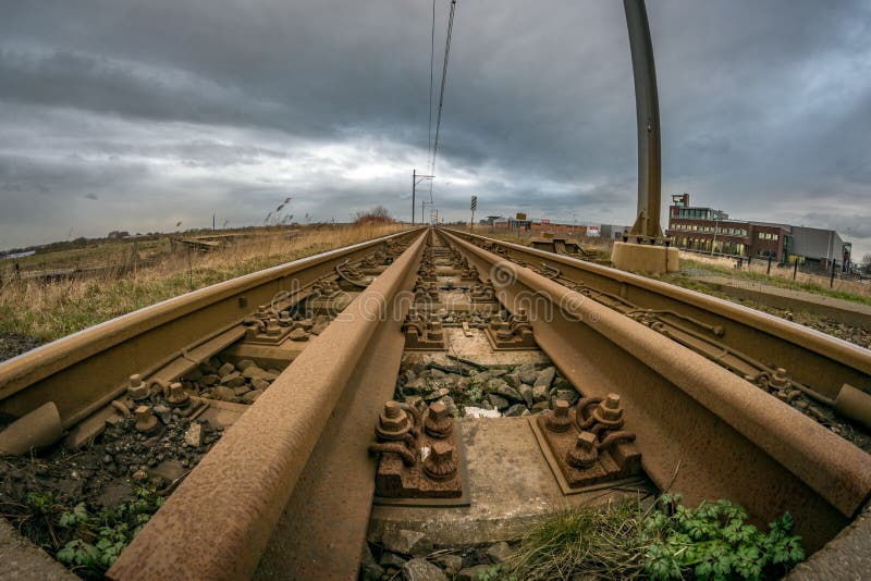 Wide angle view of a rusty railroad leading into the distance stock image Wide angle view of a rusty railroad leading into the distance stock image