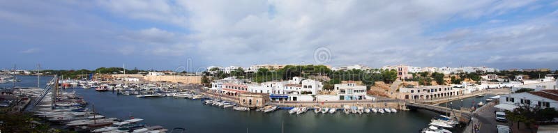 A wide panorama view of the town of ciutadella in menorca showing boats moored along the canal and surrounding buildings stock photo A wide panorama view of the town of ciutadella in menorca showing boats moored along the canal and surrounding buildings stock photo