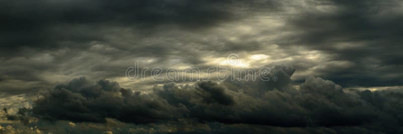 Wide panoramic view of a gloomy dramatic sky with dense cumulus clouds royalty free stock images