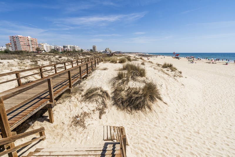 Wide Sandy Beach with Wooden Bridges Along Dunes in Monte Gordo ...