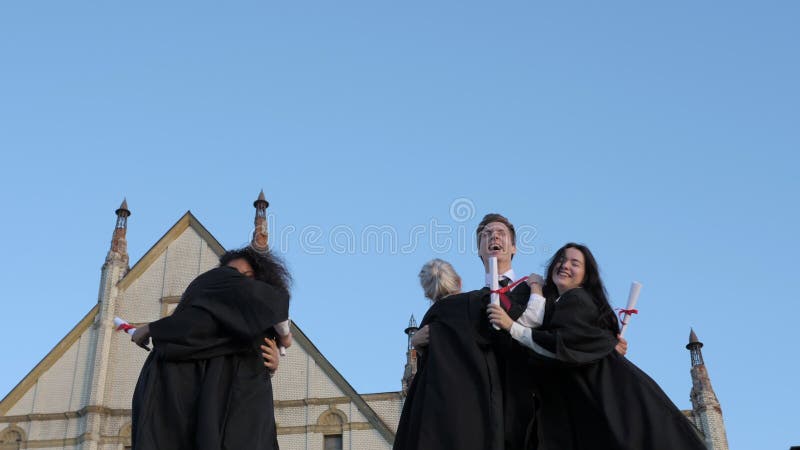 Graduation caps thrown in the air.