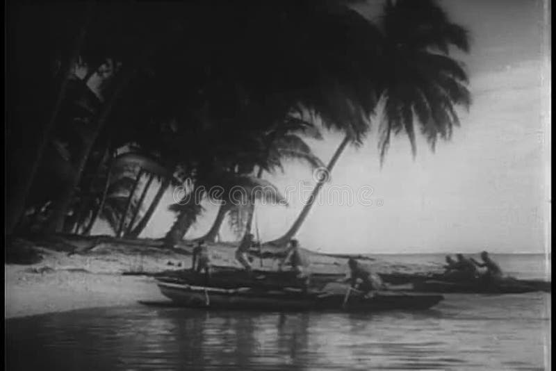 Wide shot natives arriving on island in canoes