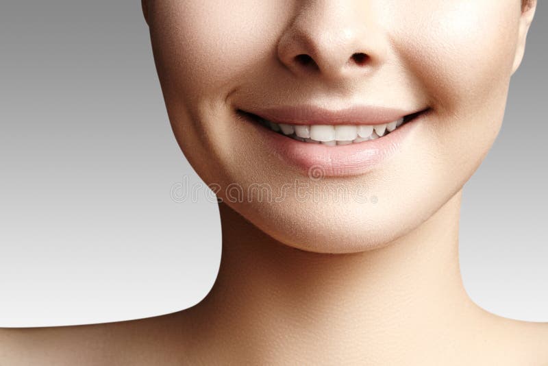 Wide smile of young beautiful woman with perfect healthy white teeth on grey background. Dental whitening, ortodont, care tooth and wellness. Natural makeup on perfect face. Wide smile of young beautiful woman with perfect healthy white teeth on grey background. Dental whitening, ortodont, care tooth and wellness. Natural makeup on perfect face.