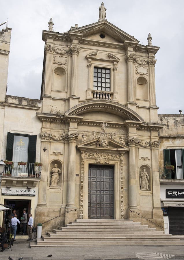 Pictured is a view of the entire front of the Church of Santa Maria della Grazia in Piazza Sant`Oronzo, Lecce, Italy. St. Peter and St. Paul statues are in the niches. Above the door is the Madonna with child and angels. Pictured is a view of the entire front of the Church of Santa Maria della Grazia in Piazza Sant`Oronzo, Lecce, Italy. St. Peter and St. Paul statues are in the niches. Above the door is the Madonna with child and angels.