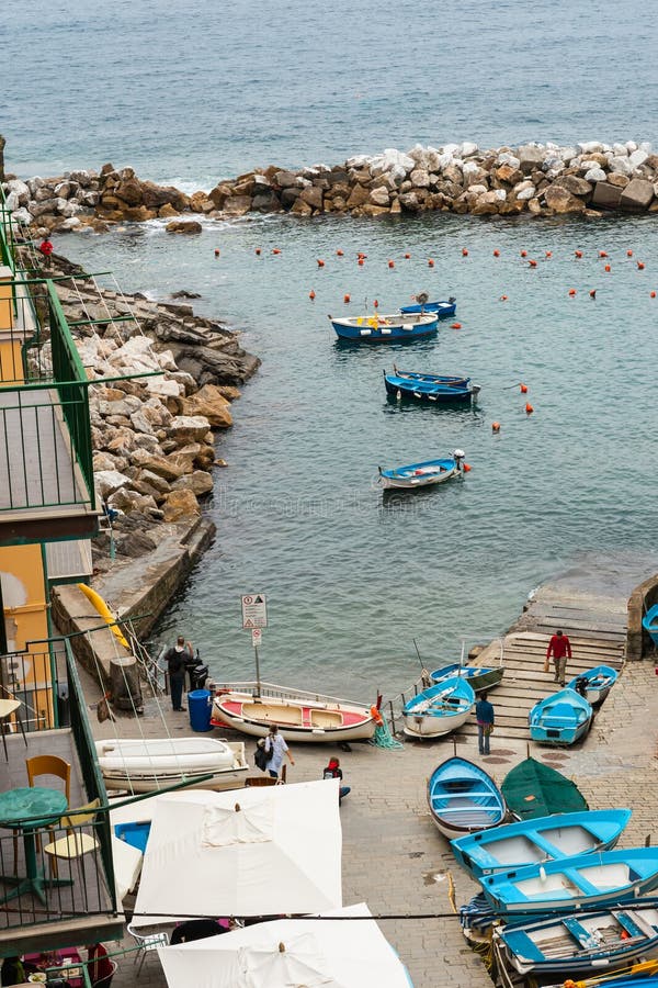 Riomaggiore Italy - April 24 2011 View of small Cinque Terre bay with fishing boats and people. Riomaggiore Italy - April 24 2011 View of small Cinque Terre bay with fishing boats and people