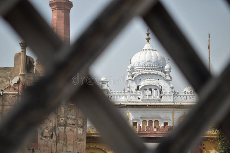 LAHORE FORT, PAKISTAN - JANUARY 20, 2017: view of maharajah ranjit singh samadhi from criss cross frame for background. LAHORE FORT, PAKISTAN - JANUARY 20, 2017: view of maharajah ranjit singh samadhi from criss cross frame for background