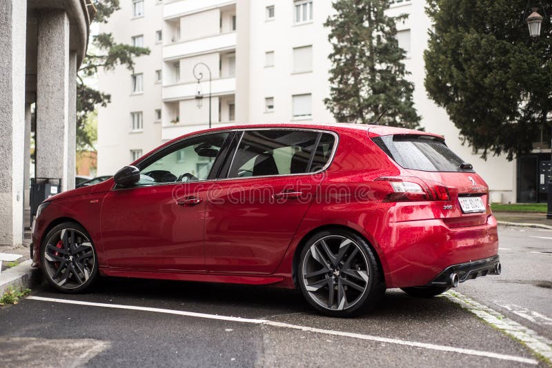 Mulhouse - France - 2 April 2024 - profile view of red peugeot 308 GTI parked in the street. Mulhouse - France - 2 April 2024 - profile view of red peugeot 308 GTI parked in the street