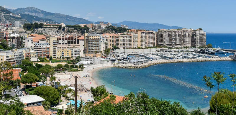Top view of Cap d`Ail beach, hotels and harbor. The water is crystal clear, and the atmosphere on the beaches is special. Top view of Cap d`Ail beach, hotels and harbor. The water is crystal clear, and the atmosphere on the beaches is special