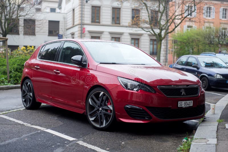 Mulhouse - France - 2 April 2024 - front view of red peugeot 308 GTI parked in the street. Mulhouse - France - 2 April 2024 - front view of red peugeot 308 GTI parked in the street