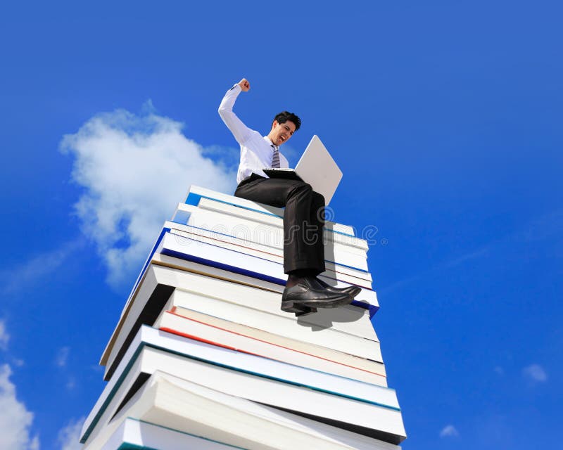 Knowledge is power - Happy business man using pc computer and sitting on a stack Of Books. Knowledge is power - Happy business man using pc computer and sitting on a stack Of Books