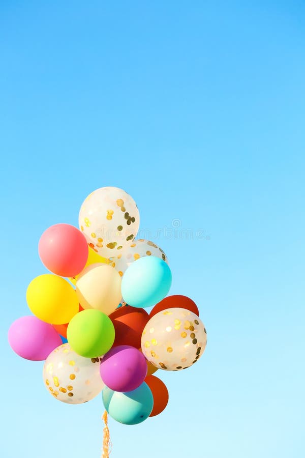 Many colorful balloons against blue sky on sunny day. Many colorful balloons against blue sky on sunny day