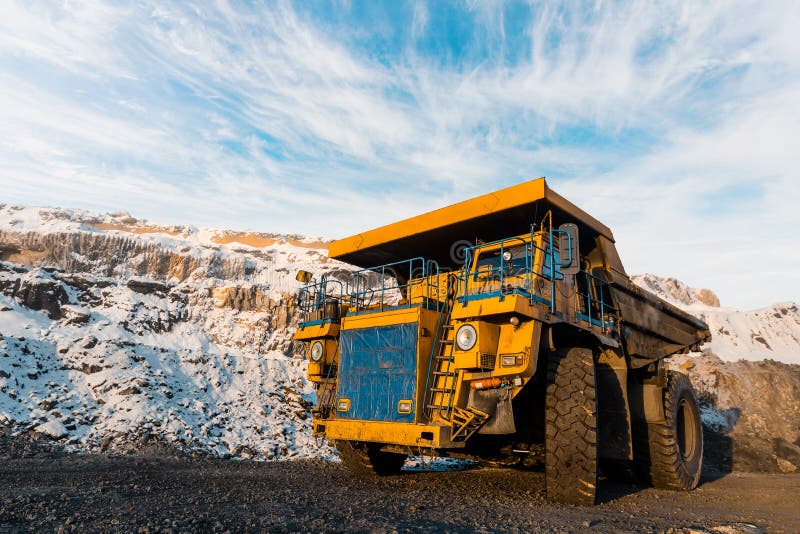 Large quarry dump truck. Loading the rock in the dumper. Loading coal into body work truck. Mining truck mining machinery, to transport coal from open-pit as the Coal. Production useful minerals. Large quarry dump truck. Loading the rock in the dumper. Loading coal into body work truck. Mining truck mining machinery, to transport coal from open-pit as the Coal. Production useful minerals.