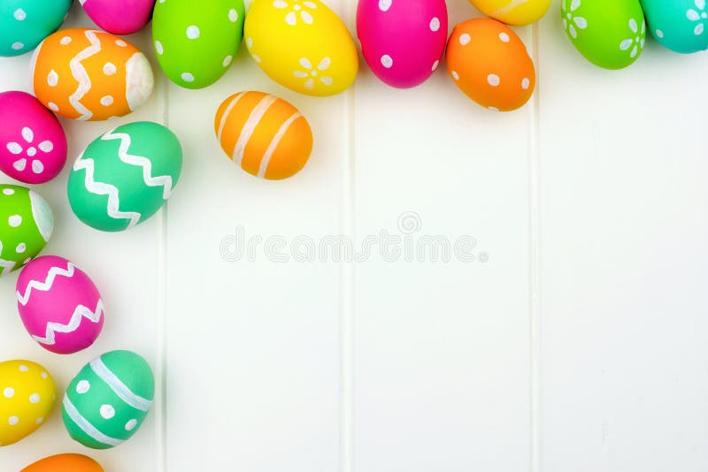 Colorful Easter egg corner border against a white wood background. Colorful Easter egg corner border against a white wood background