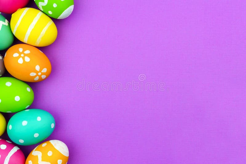 Colorful Easter egg side border over a soft purple paper background. Colorful Easter egg side border over a soft purple paper background