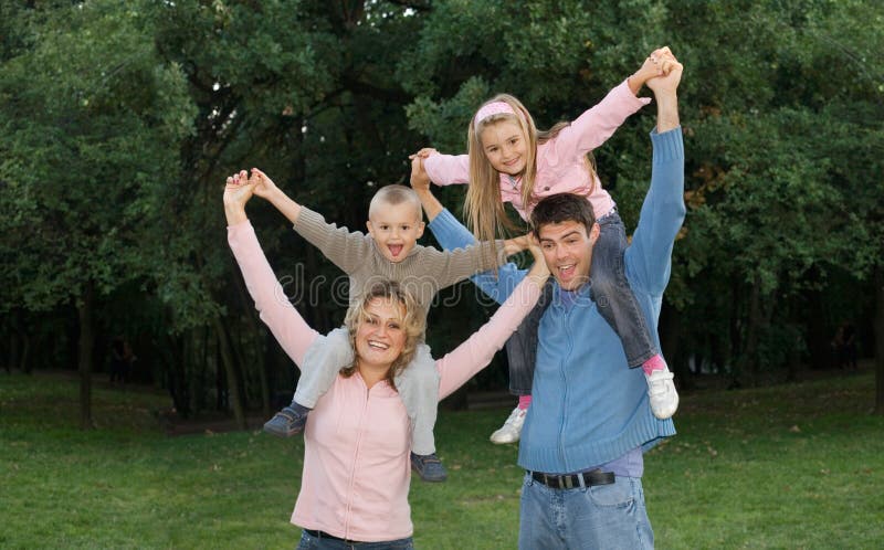 Young couple with children playing outside. Young couple with children playing outside