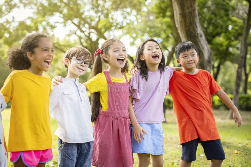 Multi-ethnic group of school kids laughing and embracing. Multi-ethnic group of school kids laughing and embracing