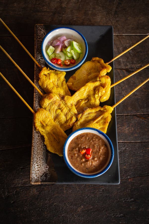 Wieprzowina satay z tajlandzkimi pikantno?? i arachidowym kumberlandem na czarnym talerzu umieszczaj? cym na drewno stole obraz stock
