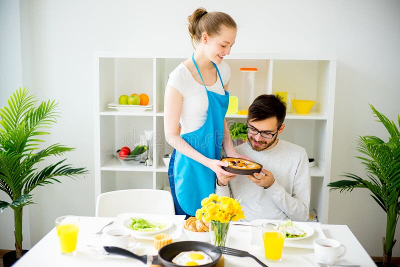 Wife cooking for husband stock image. Image of beverage 93357933