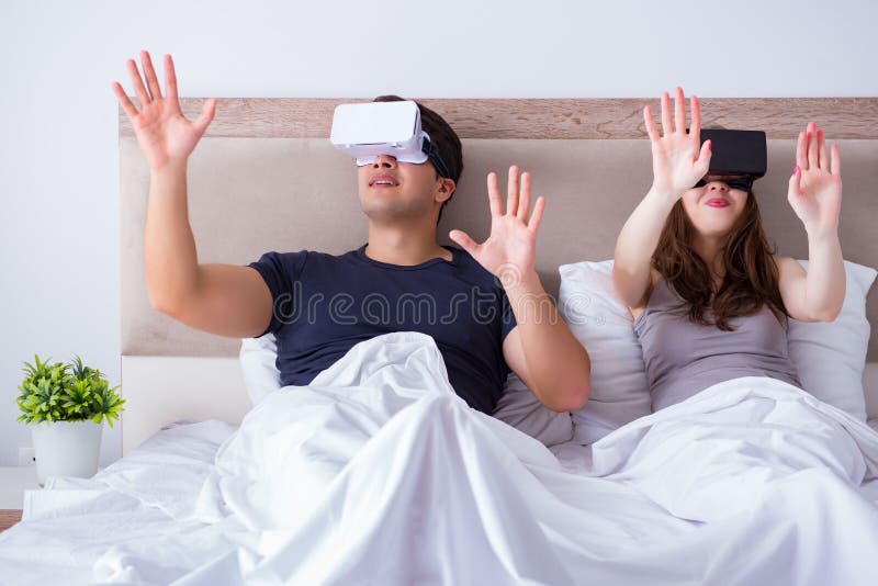 The Wife and Husband with Virtual Reality Goggles in the Bed Stock ...