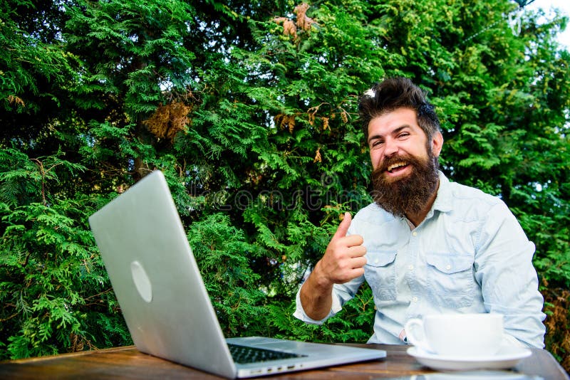 Wifi and laptop. Drink coffee and work faster. Bearded man successful freelance worker. Remote job. Freelance professional occupation. Good job expression. Well done. Hipster busy with freelance. Wifi and laptop. Drink coffee and work faster. Bearded man successful freelance worker. Remote job. Freelance professional occupation. Good job expression. Well done. Hipster busy with freelance.