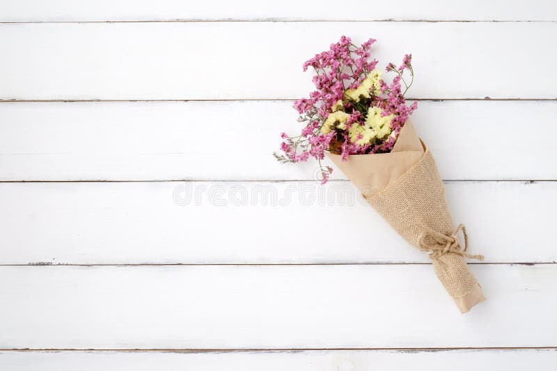 Wild flower bouquet on vintage white wood background stock images