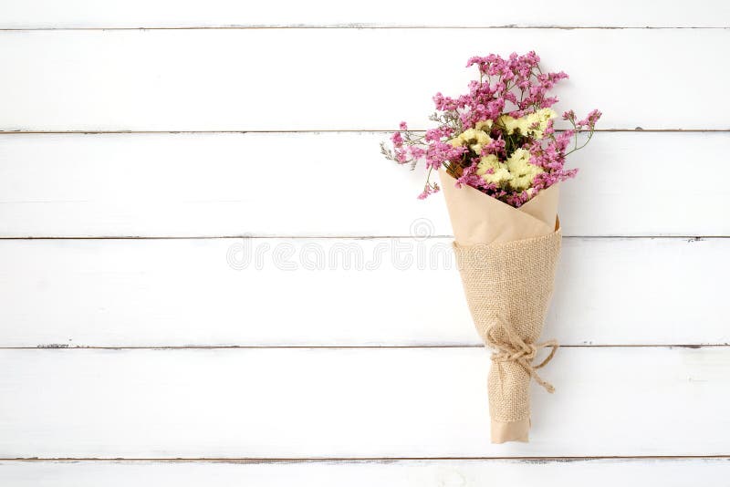 Wild flower bouquet on vintage white wood background stock photos