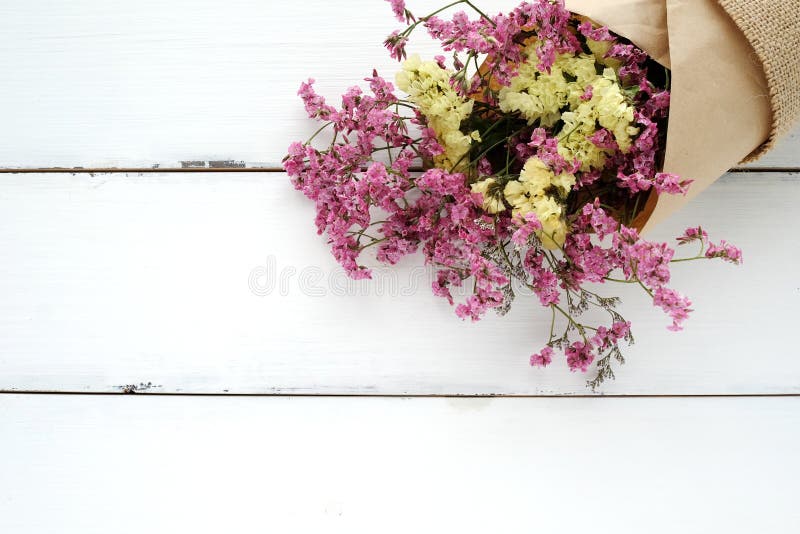 Wild flower bouquet on vintage white wood background stock image