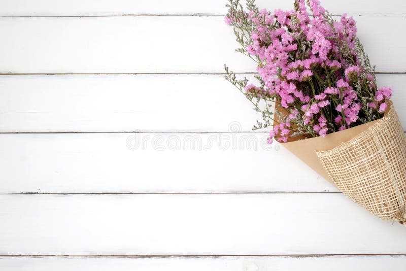 Wild flower bouquet on vintage white wood background royalty free stock photography