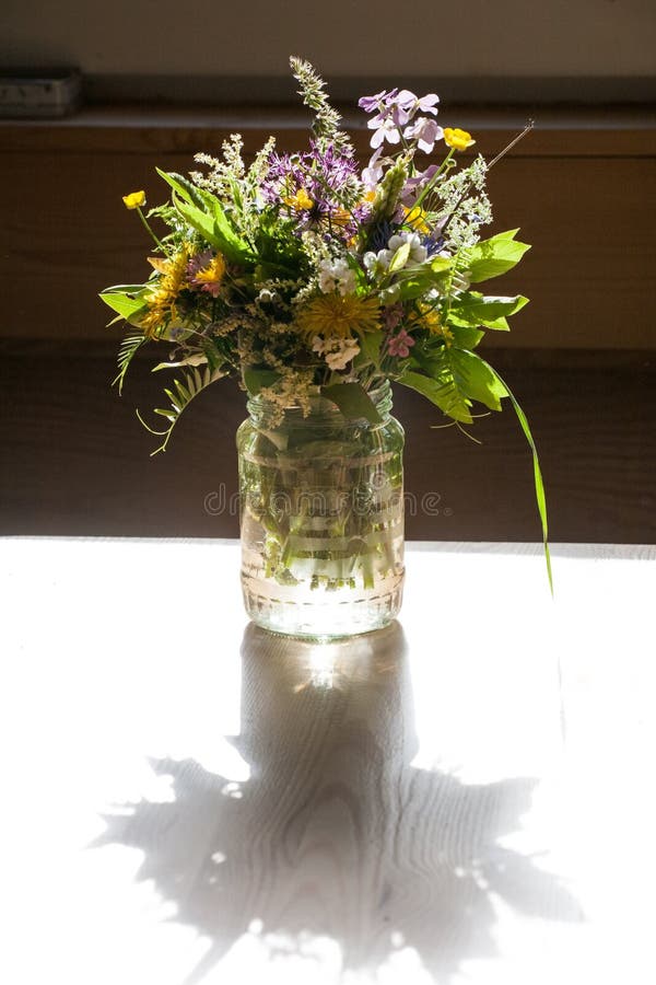 Wild flowers in glass jar stock image. Image of dark 133197699