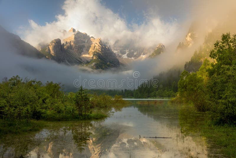 Wild Mountains Lake at foggy sunrise. Landscape, Alps, Italy, E royalty free stock photography Wild Mountains Lake at foggy sunrise. Landscape, Alps, Italy, E royalty free stock photography