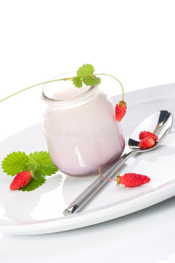 Closeup of open jar of organic yogurt and delicious wild strawberries. Closeup of open jar of organic yogurt and delicious wild strawberries