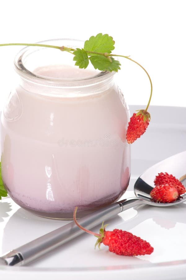 Closeup of open jar of organic yogurt and delicious wild strawberries. Closeup of open jar of organic yogurt and delicious wild strawberries