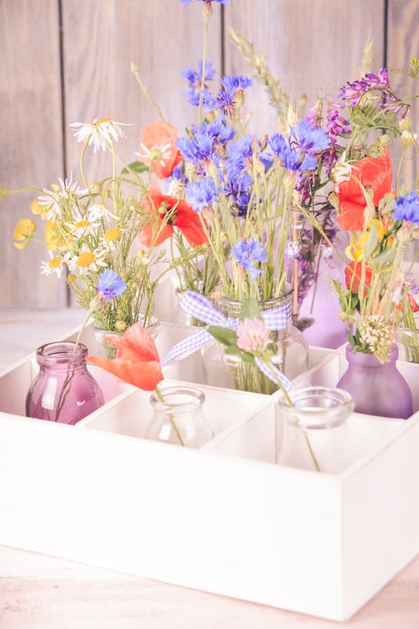 Wildflowers in bottles stock photo. Image of gift, daisy 56621062