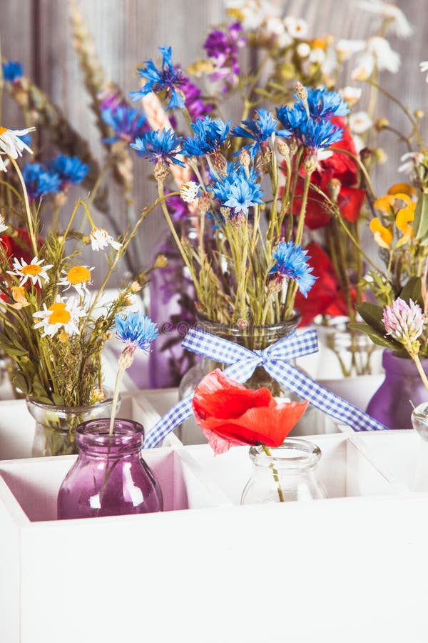 Wildflowers in bottles stock image. Image of cornflowers 81017831