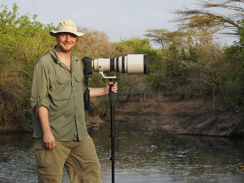 Wildlife Photographer With Long Lens On Camera In Africa Stock Photo