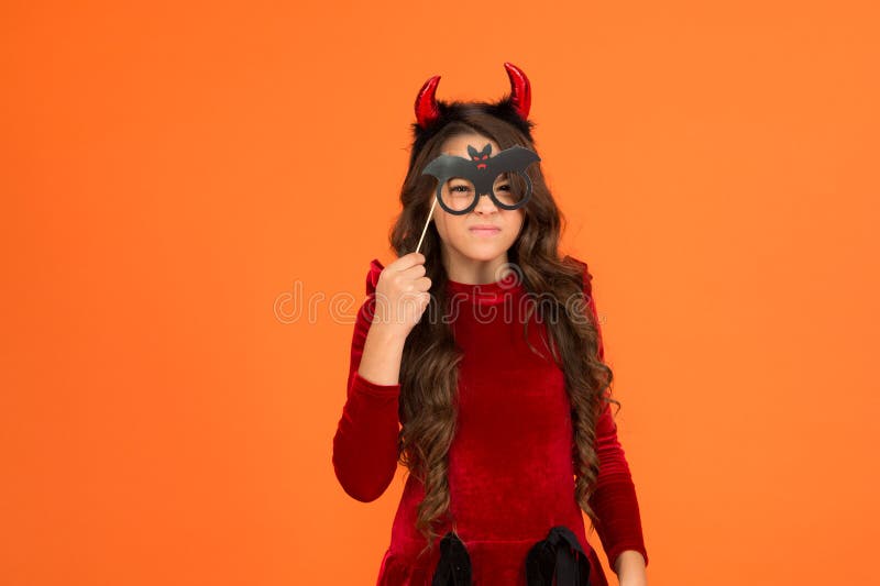 will terrify you. child celebrate autumn holiday. teenage girl in devil horns celebrate halloween. happy halloween royalty free stock photo